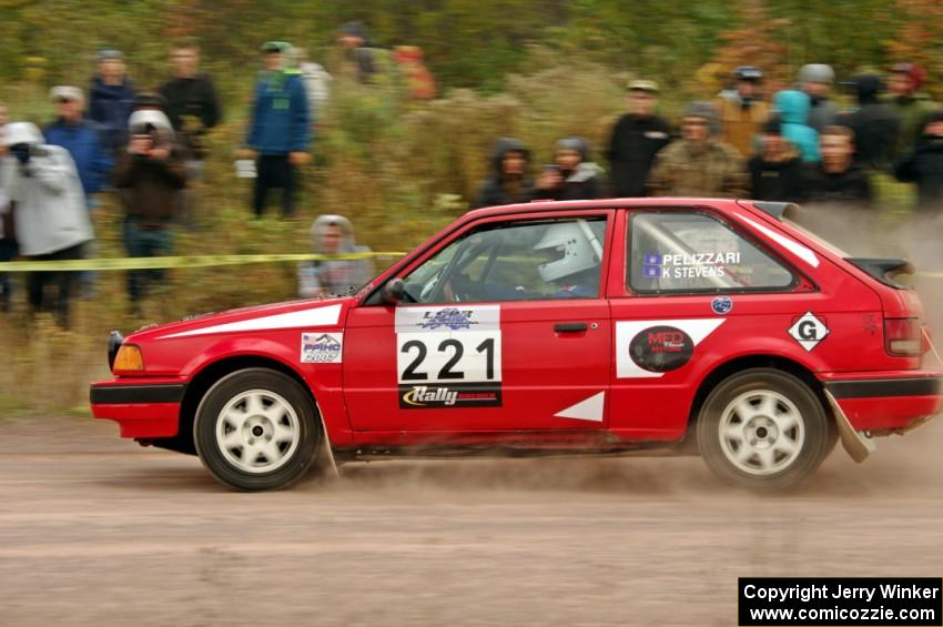 Jimmy Pelizzari / Kate Stevens Mazda 323GTX comes through the SS1 (Green Acres I) spectator area.