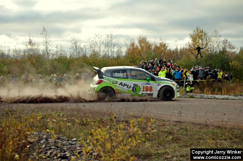 Arkadiusz Gruszka / Lukasz Wronski Mitsubishi Mirage RS comes through the SS15 (Green Acres II) spectator area.