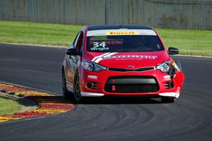 Kris Wright's Kia Forte Koup limps through turn 14 on the first lap.