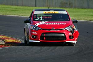 Kris Wright's Kia Forte Koup limps through turn 14 on the first lap.