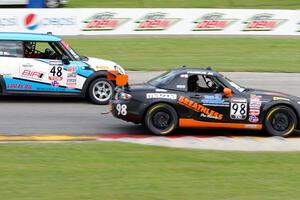 Ernie Francis, Jr.'s Mazda MX-5 passes Tom Noble's MINI Cooper