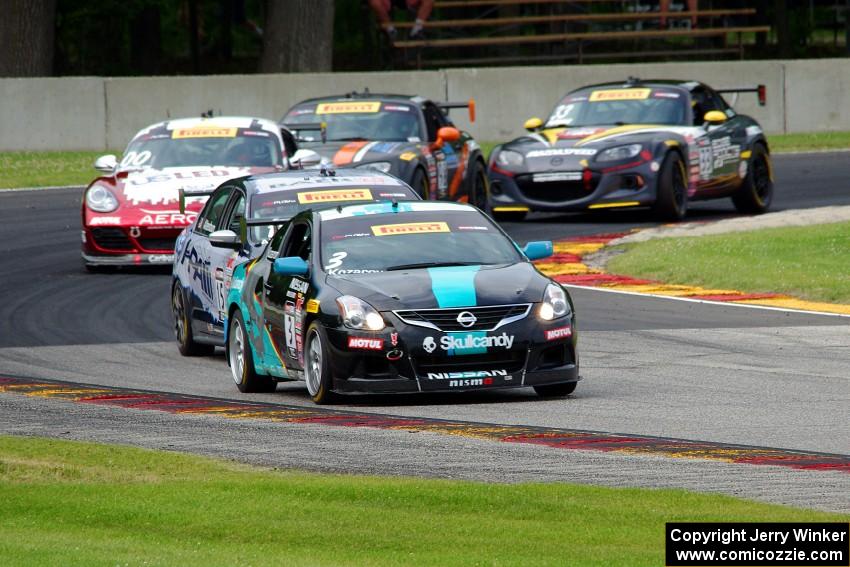 Vesko Kozarov's Nissan Altima leads the field  at turn 6 on the second lap.