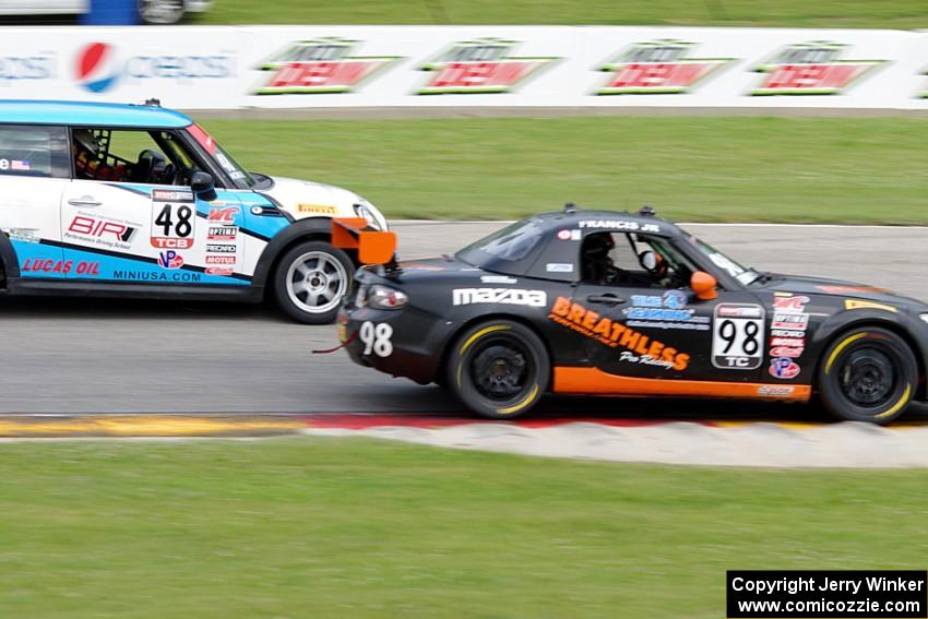 Ernie Francis, Jr.'s Mazda MX-5 passes Tom Noble's MINI Cooper