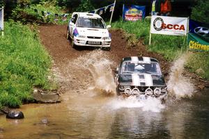 Patrick Lilly / Kevin Mullan Mazda RX-3 and Patrick Farrell / Sean O'Reilly Subaru Impreza at the flying finish of SS1.