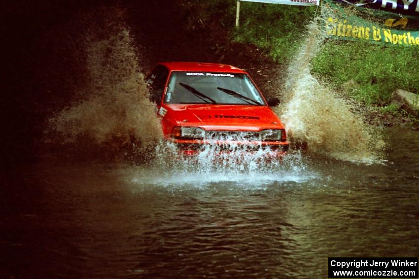 Gail Truess / Jeff Secor Mazda 323GTX at the flying finish of Stony Crossing, SS1.