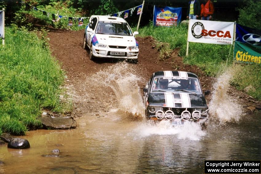 Patrick Lilly / Kevin Mullan Mazda RX-3 and Patrick Farrell / Sean O'Reilly Subaru Impreza at the flying finish of SS1.