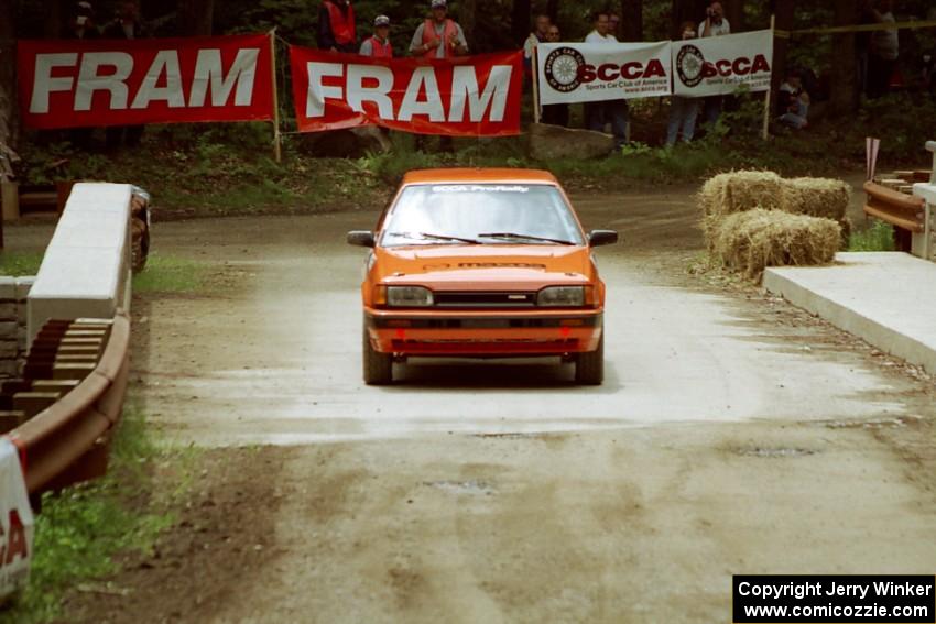 Gail Truess / Jeff Secor Mazda 323GTX comes through the spectator area at Phasa, SS4.