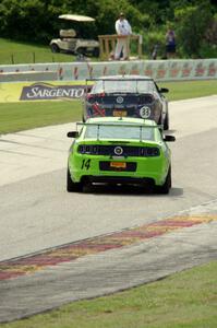 Nate Stacy's Ford Mustang Boss 302 chases Dan Martinson's Ford Mustang Boss 302