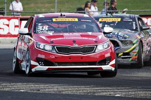 Mark Wilkins' Kia Optima and Dan Martinson's Ford Mustang Boss 302