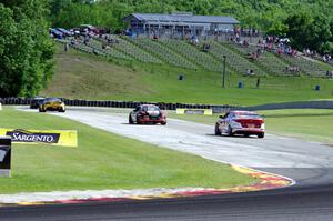 Michael Cooper's Chevy Camaro Z28 leads , Lou Gigliotti's Aston Martin Vantage GT4, Jack Baldwin's Porsche Cayman and