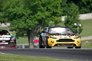 Lou Gigliotti's Aston Martin Vantage GT4 passes Jack Baldwin's Porsche Cayman