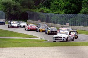 Dean Martin's Ford Mustang Boss 302 leads the field into turn three on the first lap.