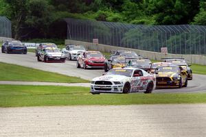 Dean Martin's Ford Mustang Boss 302 leads the field into turn three on the first lap.