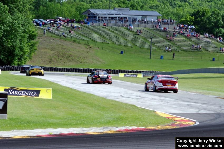 Michael Cooper's Chevy Camaro Z28 leads , Lou Gigliotti's Aston Martin Vantage GT4, Jack Baldwin's Porsche Cayman and