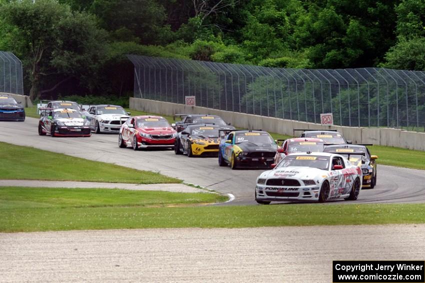Dean Martin's Ford Mustang Boss 302 leads the field into turn three on the first lap.