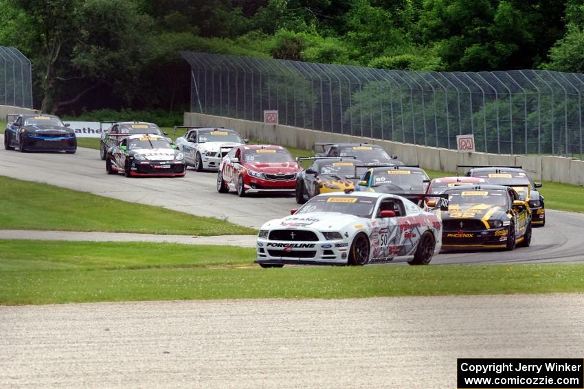 Dean Martin's Ford Mustang Boss 302 leads the field into turn three on the first lap.