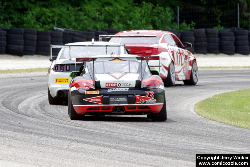 Jack Baldwin's Porsche Cayman chases Mark Wilkins' Kia Optima and Dean Martin's Ford Mustang Boss 302