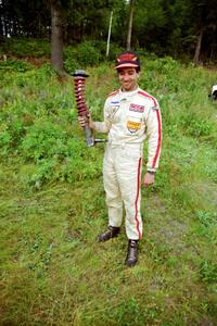 Andrew Havas displays the bent strut from his Mazda RX-7.