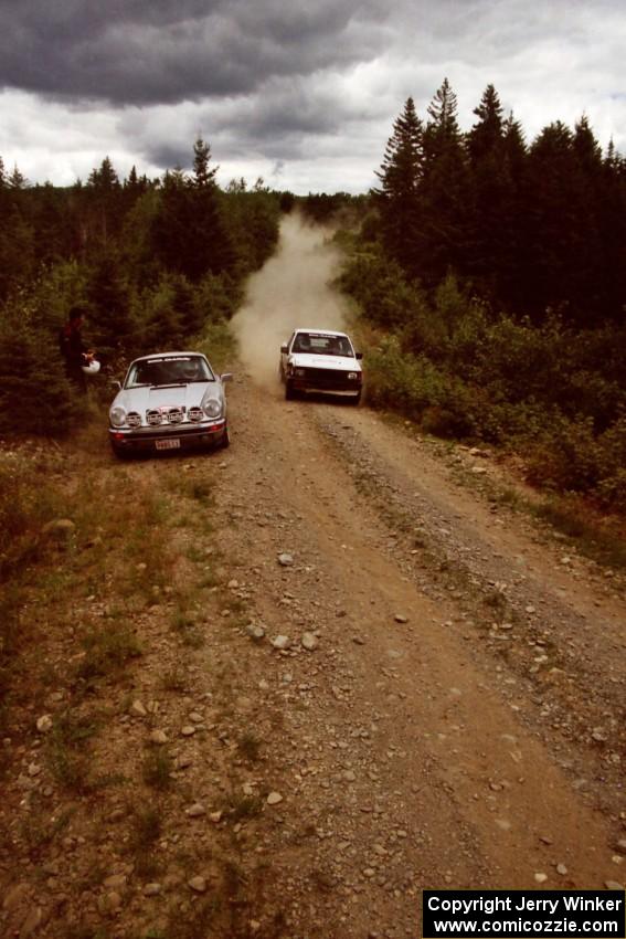 Anders Green / Chuck Cox Mitsubishi Mighty Max passes the Max Stratton / Charles Theocles Porsche 911 Carrera on SS6.