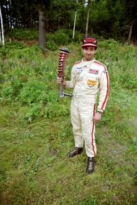 Andrew Havas displays the bent strut from his Mazda RX-7.