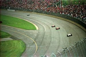 Four cars head into the tri-oval.