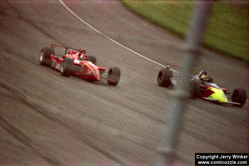 Jimmy Vasser's Reynard 96i/Honda about to put a lap on André Ribeiro's Lola T-96/00/Honda