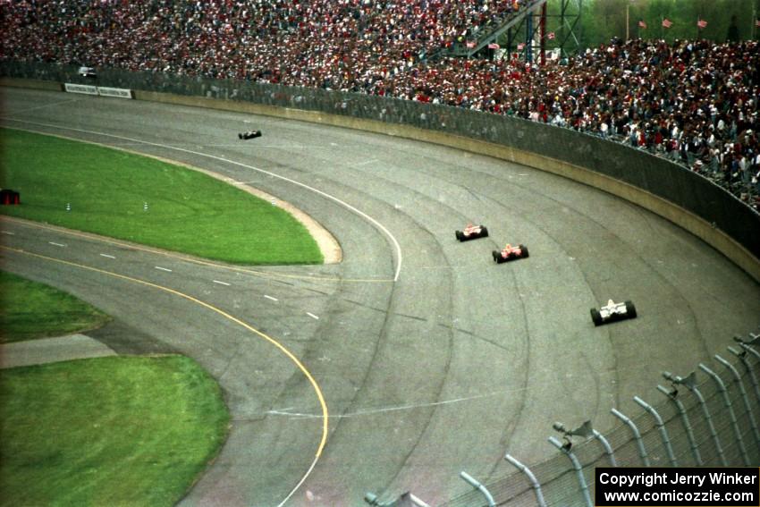 Four cars head into the tri-oval.