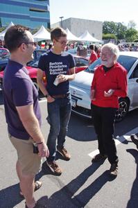 Ed Solstad talks foreign cars to a couple of passers-by.
