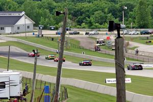 Five cars run nose to tail into turn 8.