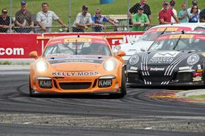 Colin Thompson's, Sloan Urry's and Alec Udell's Porsche 911 GT3 Cup cars battle into turn 5.
