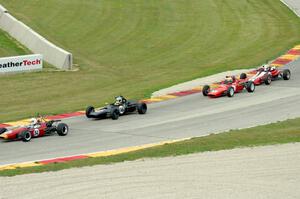 Four cars run nose-to-tail through turn 7.