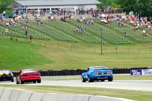 David Carpenter's Ford Mustang Mach 1 chases two other cars into turn 7.