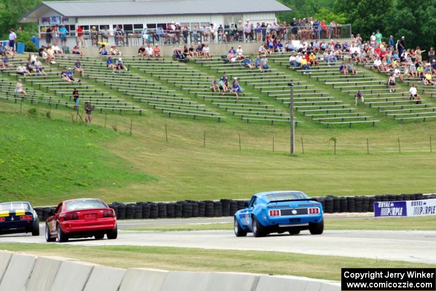 David Carpenter's Ford Mustang Mach 1 chases two other cars into turn 7.