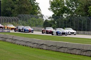 MX-5s head downhill into turn 3 on the first lap.