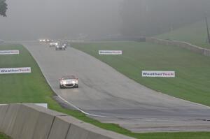 MX-5s head downhill into turn 8 in the thick fog.