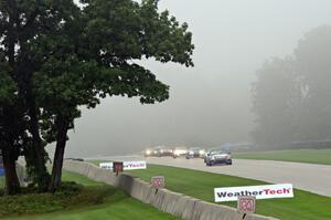 Mazda MX-5s through the Hurry Downs in the thick fog.