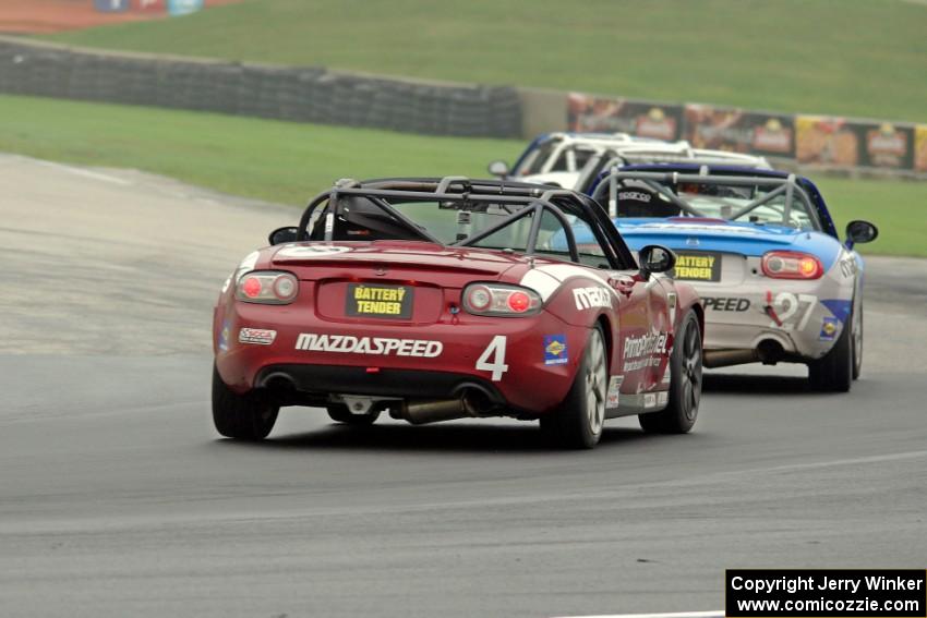 Nick Igdalsky's and Kyle Loustaunau's Mazda MX-5s follow a pair of similar cars.