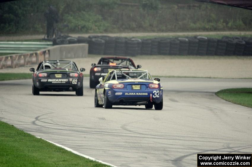 Bryan Hixon ahead of Kieron O'Rourke and Keith Jensen, all in Mazda MX-5s.