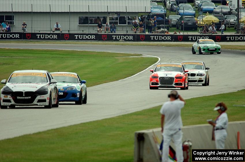 Five more ST cars come out of turn 3.