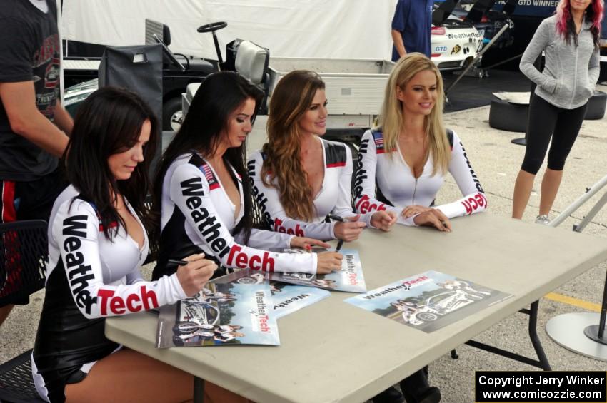 The WeatherTech girls sign autographs.