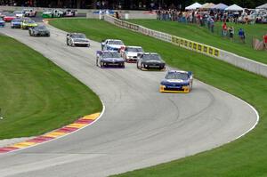 Chase Elliots's Chevy Camaro leads the field through the Hurry Downs on the first lap.