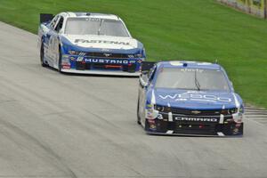 Ty Dillon's Chevy Camaro and Chris Buescher's Ford Mustang