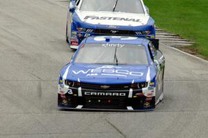 Ty Dillon's Chevy Camaro and Chris Buescher's Ford Mustang