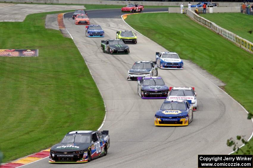 The first half of the field comes through the Hurry Downs on the pace lap.