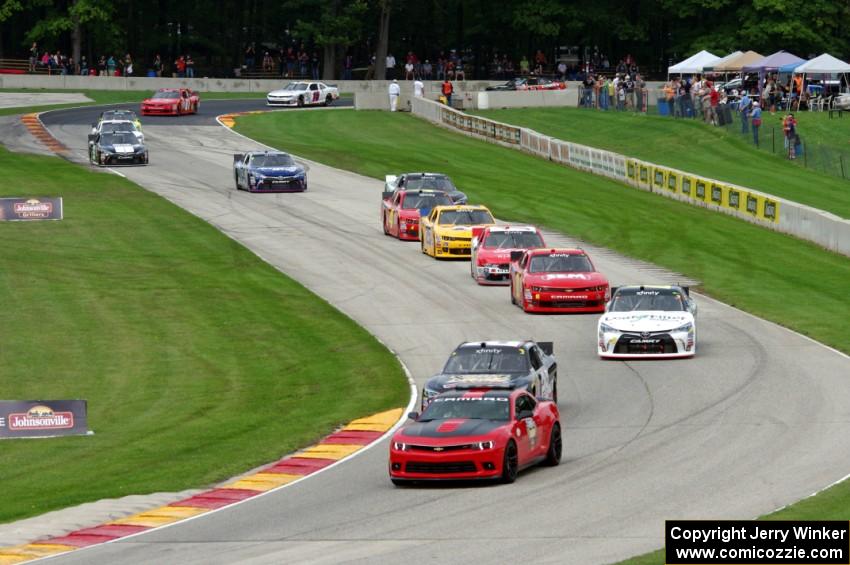 The second half of the field comes through the Hurry Downs on the pace lap.