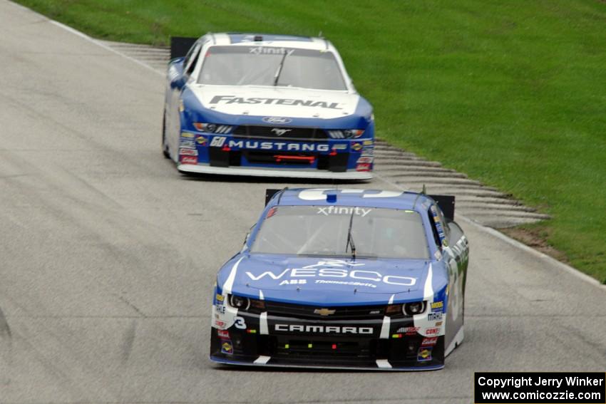 Ty Dillon's Chevy Camaro and Chris Buescher's Ford Mustang