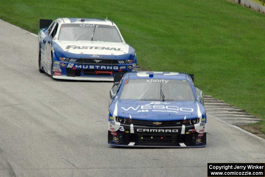 Ty Dillon's Chevy Camaro and Chris Buescher's Ford Mustang