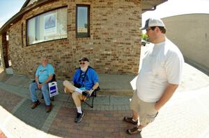 Tim Winker, Clarence Westberg and Ben Wedge take a break in the shade.