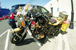 Motorcycle parked outside of the car show.