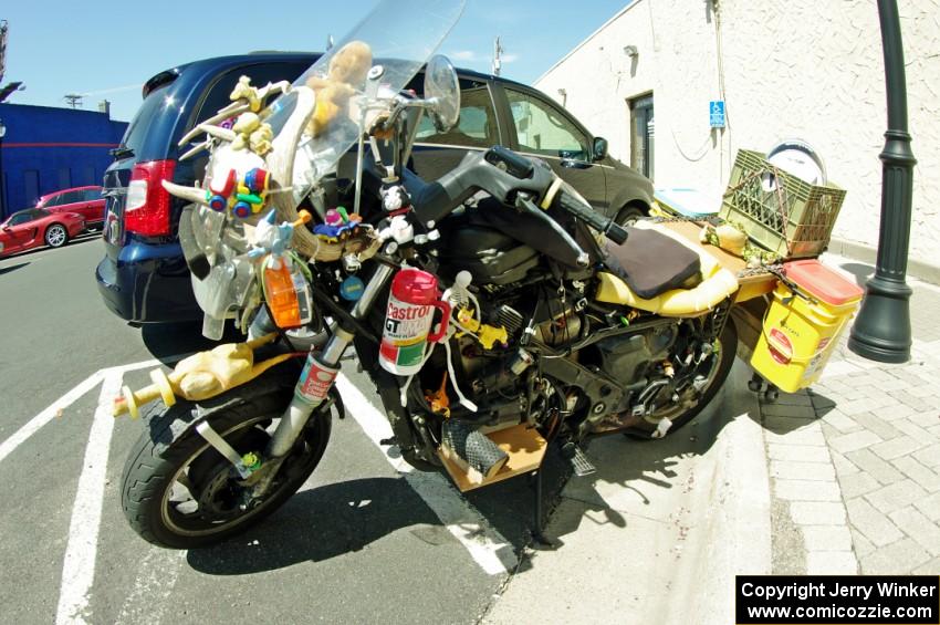 Motorcycle parked outside of the car show.